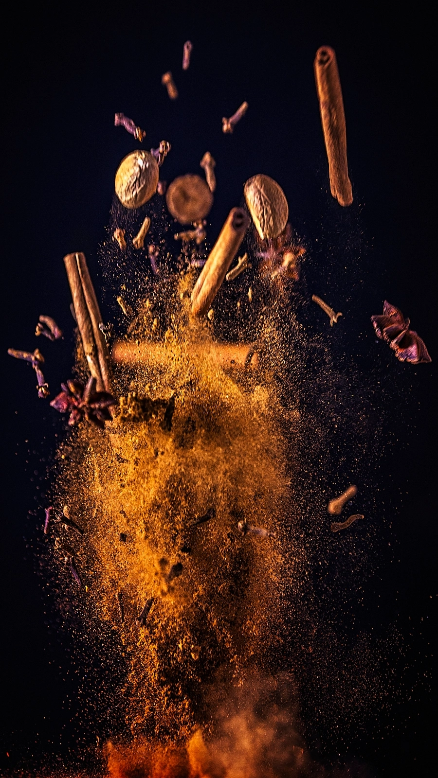 Controlled spice burst created with tabletop rigging for slow-motion food cinematography.