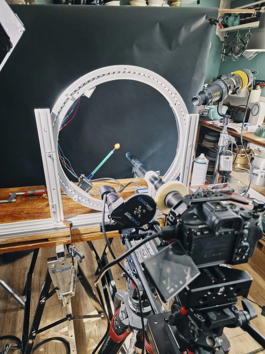Motion control ring rig with camera setup for tabletop slow-motion cinematography.