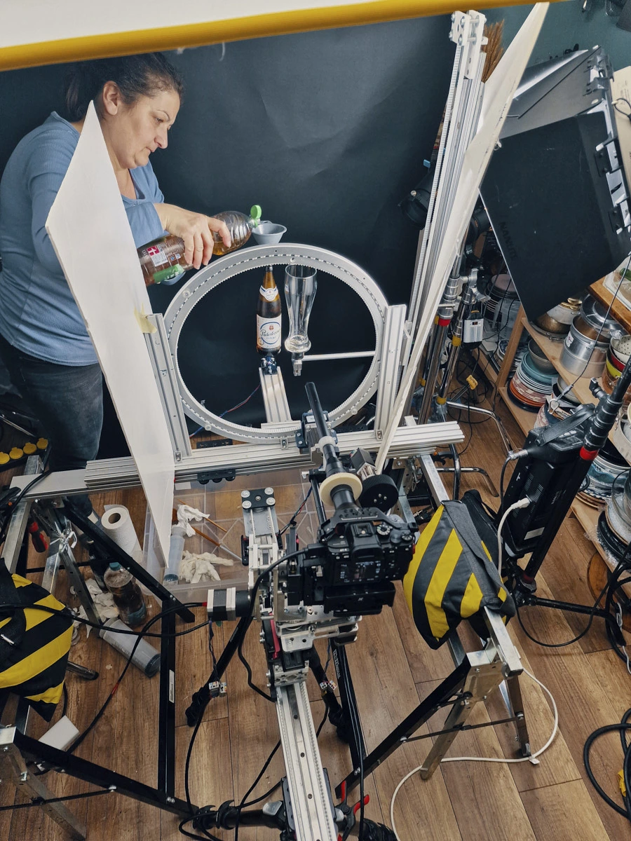 Behind-the-scenes tabletop rigging studio setup with camera slider, lighting and food motion rig.